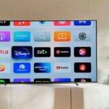 a flat screen tv sitting on top of a white cabinet