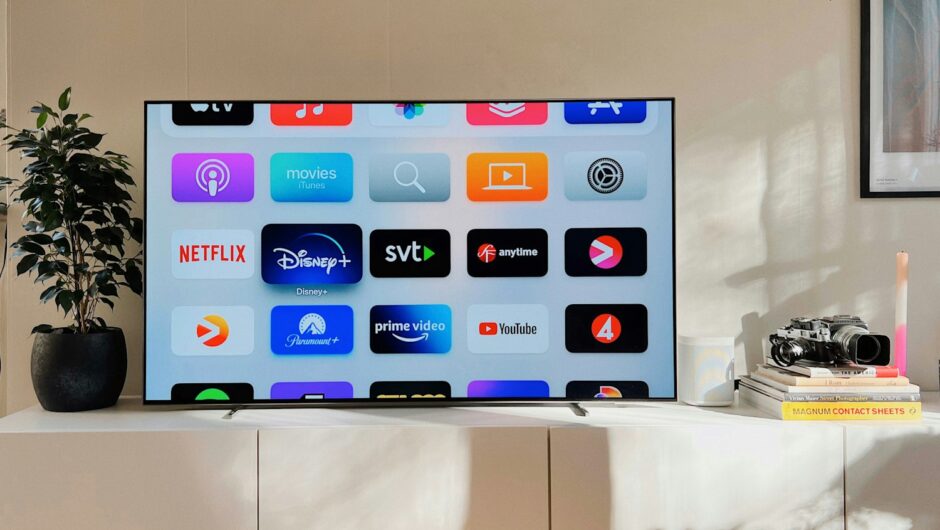 a flat screen tv sitting on top of a white cabinet