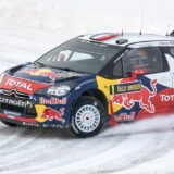 a rally car driving on a snowy road