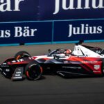 a man driving a race car on a track