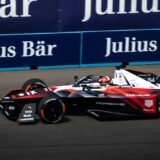 a man driving a race car on a track