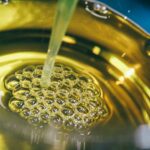 a metal bowl filled with yellow liquid
