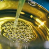 a metal bowl filled with yellow liquid